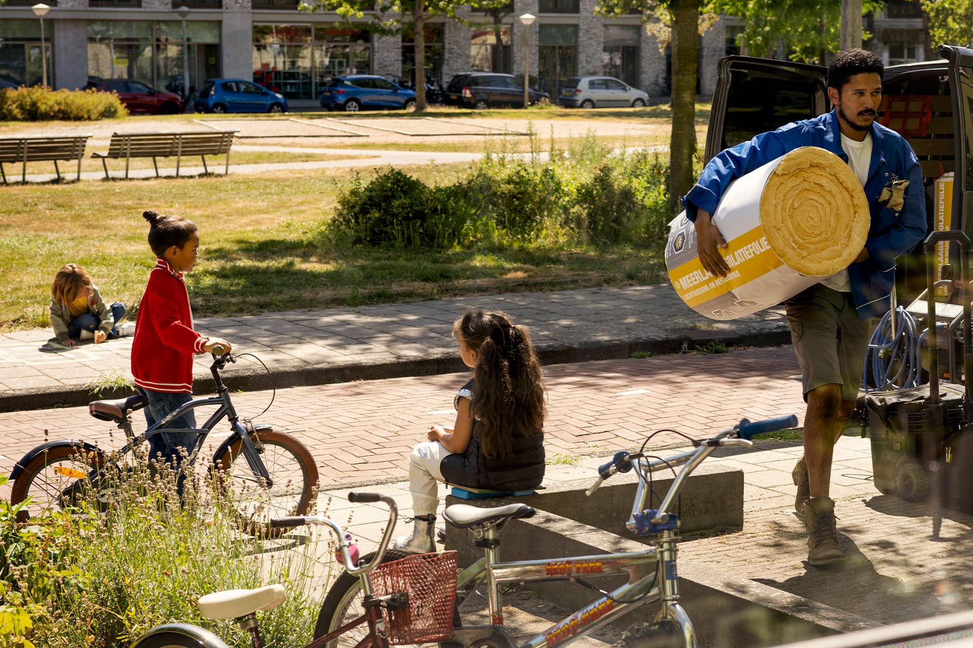 Man loopt met isolatierol naar de voordeur van een woning